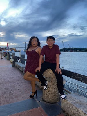 Cristobal Leyva and her nephew Victor Salazar pose for a photo on River Street, one of the locations for their dance videos.